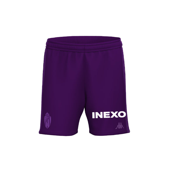 Deportista en camiseta y pantalones cortos sobre fondo violeta